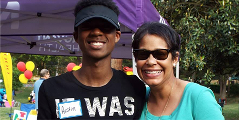 Young Austin posing outside with a woman Young Austin posing and smiling with a woman